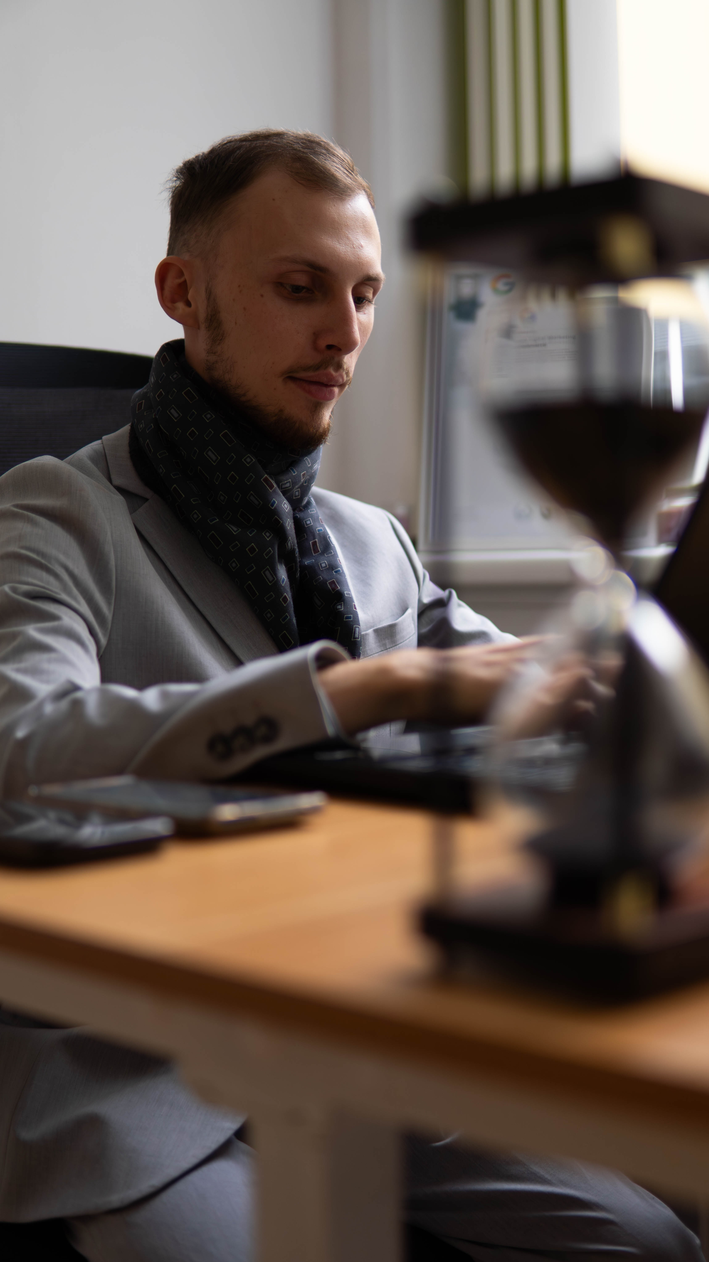 A render of three white cylindrical columns, against a warm creme background
